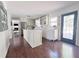 Bright kitchen with white cabinets, a center island, and stainless steel appliances at 4424 Lower Fayetteville Rd, Sharpsburg, GA 30277