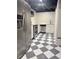 Modern kitchen featuring stainless steel appliances and stylish black and white checkered floors at 4424 Lower Fayetteville Rd, Sharpsburg, GA 30277
