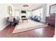 Cozy living room with a fireplace, hardwood floors, and natural light at 4424 Lower Fayetteville Rd, Sharpsburg, GA 30277