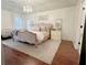 Main bedroom featuring hardwood floors, a large bed, and neutral decor at 4424 Lower Fayetteville Rd, Sharpsburg, GA 30277