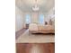 Primary bedroom with a chandelier, hardwood floors, and neutral decor at 4424 Lower Fayetteville Rd, Sharpsburg, GA 30277