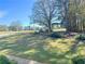 A manicured lawn with trees and a small wooden fence in the background at 4424 Lower Fayetteville Rd, Sharpsburg, GA 30277