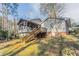 Home exterior with spacious backyard, wooden deck, and lush landscaping at 4641 Waterford Ct, Atlanta, GA 30338