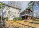 This house has a screened porch and steps in the backyard with trees and a light sky at 4641 Waterford Ct, Atlanta, GA 30338