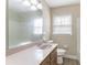 This bathroom features a large mirror, wood cabinets and a window at 4641 Waterford Ct, Atlanta, GA 30338