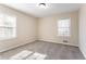 This spacious bedroom has gray carpet, two windows, and light beige walls at 4641 Waterford Ct, Atlanta, GA 30338
