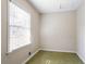 This bedroom has green carpet and one window at 4641 Waterford Ct, Atlanta, GA 30338