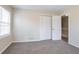 A standard bedroom offers neutral carpeting and white bifold closet doors for a serene living space at 4641 Waterford Ct, Atlanta, GA 30338