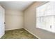 This bedroom has green carpet, one window and a closet at 4641 Waterford Ct, Atlanta, GA 30338