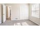 This bedroom has gray carpet, one window and closet with bi-fold doors at 4641 Waterford Ct, Atlanta, GA 30338