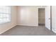 Bedroom features neutral carpeting and a window, leading to the staircase, offering a peaceful retreat at 4641 Waterford Ct, Atlanta, GA 30338