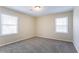 A simple bedroom design bathed in natural light, complemented by neutral carpeting and walls at 4641 Waterford Ct, Atlanta, GA 30338