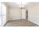Cozy dining area with a chandelier, large windows, and updated flooring, perfect for Gathering meals at 4641 Waterford Ct, Atlanta, GA 30338