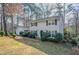 A quaint two-story house with gray siding, dark shutters, an attached garage, and a sloped front yard at 4641 Waterford Ct, Atlanta, GA 30338