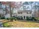 Charming two-story home featuring gray siding, black shutters, and a well-maintained front yard with mature trees at 4641 Waterford Ct, Atlanta, GA 30338