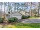 View of the home and attached garage, surrounded by lush greenery and a well-kept lawn at 4641 Waterford Ct, Atlanta, GA 30338