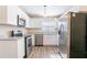 A well-lit kitchen featuring stainless steel appliances, granite countertops, and white cabinets at 4641 Waterford Ct, Atlanta, GA 30338