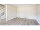 Open-concept living area with contemporary floors, neutral paint, and a staircase leading to the upper level at 4641 Waterford Ct, Atlanta, GA 30338