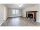 This living room has wood floors, a brick fireplace with mantel and a large window at 4641 Waterford Ct, Atlanta, GA 30338