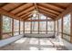 Inviting sunroom features wood-paneled ceiling, ceiling fan, and many windows at 4641 Waterford Ct, Atlanta, GA 30338