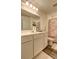 Bright bathroom featuring white vanity and cabinet with a floral shower curtain at 534 Magnolia Cir, Palmetto, GA 30268