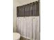 Bathroom boasts a unique shower curtain with black and white stripes, adding a modern touch at 534 Magnolia Cir, Palmetto, GA 30268