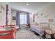 Bright Bedroom featuring two cribs, flower decor, and soft gray carpeting at 534 Magnolia Cir, Palmetto, GA 30268