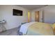 This bedroom features neutral walls, a wall-mounted TV, and gray carpet at 534 Magnolia Cir, Palmetto, GA 30268