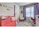 Bright Bedroom featuring a pink dresser, decorations, and soft gray carpeting at 534 Magnolia Cir, Palmetto, GA 30268