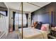 Bedroom with a canopy bed, black accent wall, and a neutral color scheme at 534 Magnolia Cir, Palmetto, GA 30268