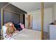 Bedroom with a canopy bed, black accent wall, and a neutral color scheme at 534 Magnolia Cir, Palmetto, GA 30268