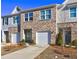 Charming townhomes featuring brick and siding exteriors, each with an attached garage and landscaped front yards at 534 Magnolia Cir, Palmetto, GA 30268