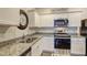 Well-lit kitchen featuring stainless steel appliances, granite countertops, and a decorative 'Bed & Breakfast' sign at 534 Magnolia Cir, Palmetto, GA 30268