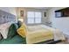 Cozy main bedroom featuring a large upholstered headboard, side tables with lamps, and bright window at 534 Magnolia Cir, Palmetto, GA 30268
