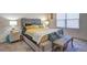 Comfortable main bedroom with a stylish upholstered bed, side tables, and a window with blinds at 534 Magnolia Cir, Palmetto, GA 30268