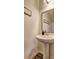 Well-maintained powder room featuring a pedestal sink, decorative mirror, and modern lighting fixtures at 534 Magnolia Cir, Palmetto, GA 30268