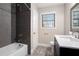 Bathroom featuring dark tiled shower and neutral wall with modern fixtures at 5700 Tracy Dr, Mableton, GA 30126