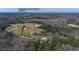 Aerial view of property showcasing 6.97 acres of land, pool, and location near Walnut Grove Elementary at 774 Forrester Cemetery Rd, Covington, GA 30014