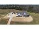 Aerial view of farmhouse with detached garage, basketball court, and long driveway on large lot at 774 Forrester Cemetery Rd, Covington, GA 30014