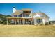 Expansive backyard featuring a covered patio with seating and an upper-level balcony overlooking the yard at 774 Forrester Cemetery Rd, Covington, GA 30014