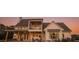 Expansive backyard featuring a covered patio with seating and an upper-level balcony overlooking the yard at sunset at 774 Forrester Cemetery Rd, Covington, GA 30014