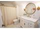 Bathroom with white vanity, gold accents, and shower with neutral-colored curtain at 774 Forrester Cemetery Rd, Covington, GA 30014