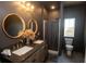 Chic bathroom featuring double vanity sinks, striking round mirrors, and a walk-in shower at 774 Forrester Cemetery Rd, Covington, GA 30014