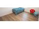 A cozy bedroom with vibrant decor, featuring playful themed chairs and wood-look floors at 774 Forrester Cemetery Rd, Covington, GA 30014