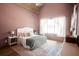Vaulted ceiling bedroom with a plush bed and ample natural light creating a cozy retreat at 774 Forrester Cemetery Rd, Covington, GA 30014