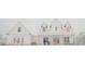 A charming two-story farmhouse has a porch and dormer windows and is covered in snow at 774 Forrester Cemetery Rd, Covington, GA 30014