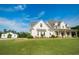 Beautiful two-story home boasts a covered porch, complemented by a sprawling green lawn and outbuilding at 774 Forrester Cemetery Rd, Covington, GA 30014