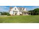 Elegant two-story home with inviting front porch, framed by a meticulously maintained, expansive green lawn at 774 Forrester Cemetery Rd, Covington, GA 30014