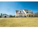 Stunning white farmhouse with a manicured front lawn and a detached garage at 774 Forrester Cemetery Rd, Covington, GA 30014