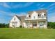 Elegant two-story home with inviting front porch, framed by lush green lawn and landscaping at 774 Forrester Cemetery Rd, Covington, GA 30014